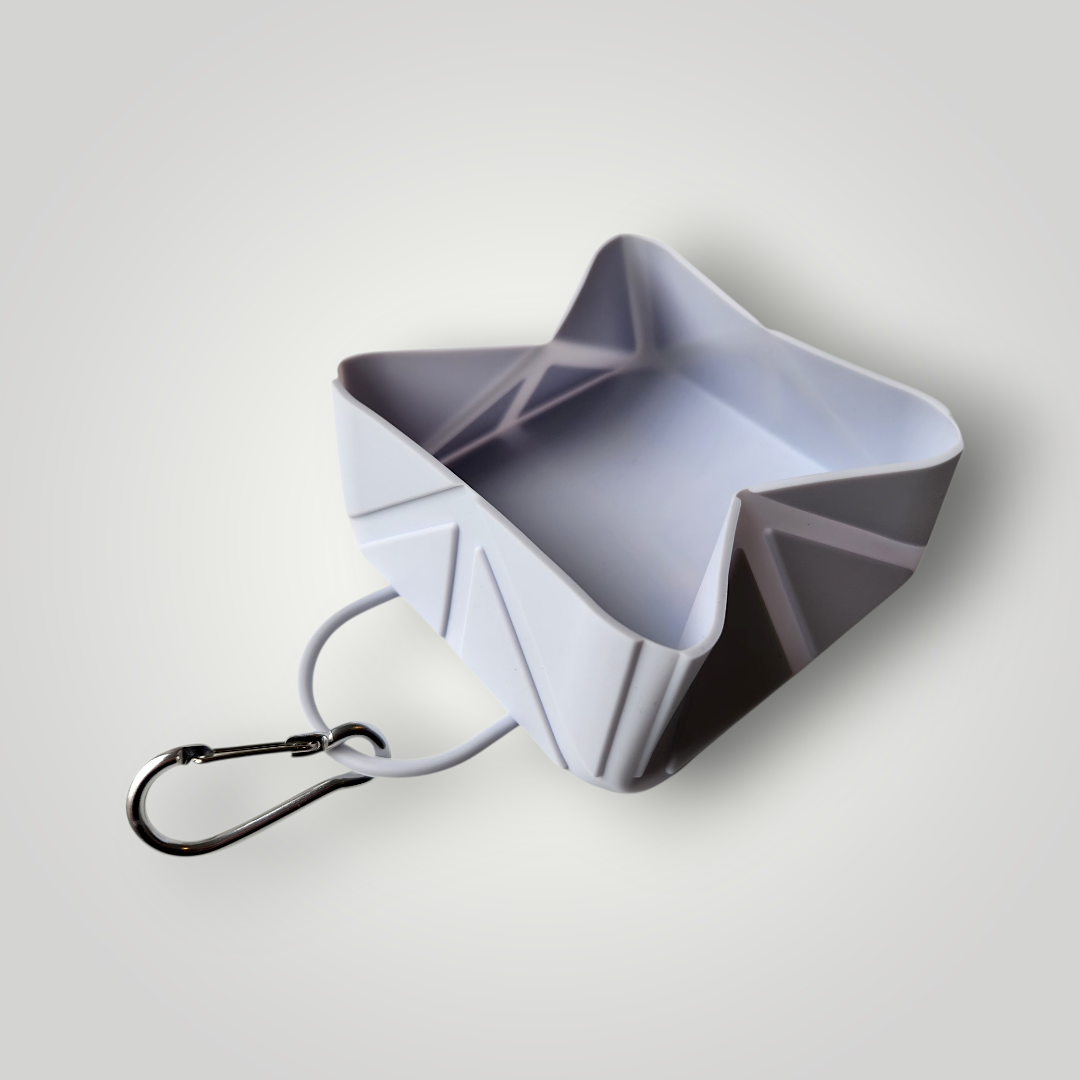 Foldable dog travel bowl by The Pawfect Trio, compact and portable pet accessory for easy feeding on the go.
