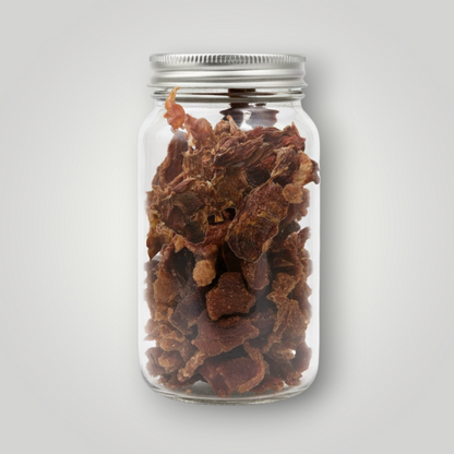 Treat Treat crocodile jerky dog treats shown in a close-up, highlighting the chewy, dried reptile meat snack for dogs.