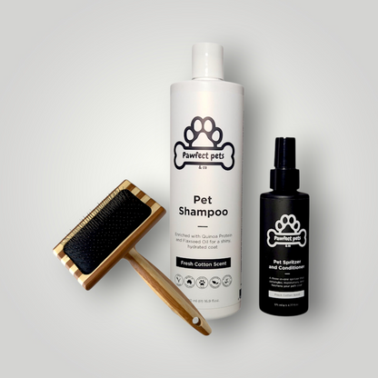 The Pawfect Trio Complete Coat Care Bundle for pets, including pet wash bottles and grooming tools, arranged on a clean surface.