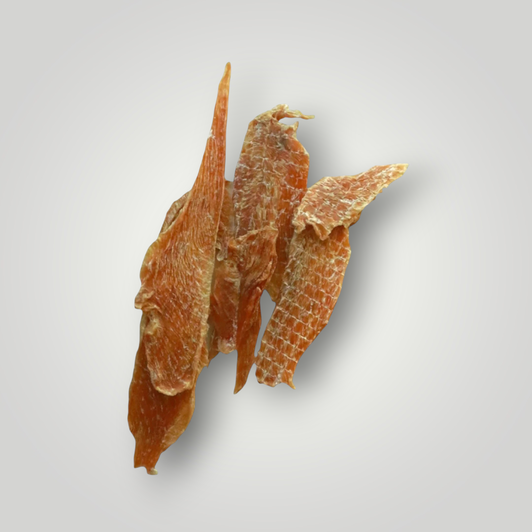 Dog treats featuring chicken jerky from Treat Treat, showing savory, dried chicken strips on a white background.