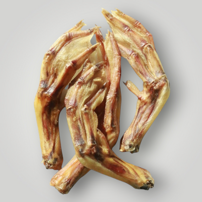 Treat Treat Duck Feet dog treats, natural chewy snack for dogs, shown in close-up with textured duck feet pieces.