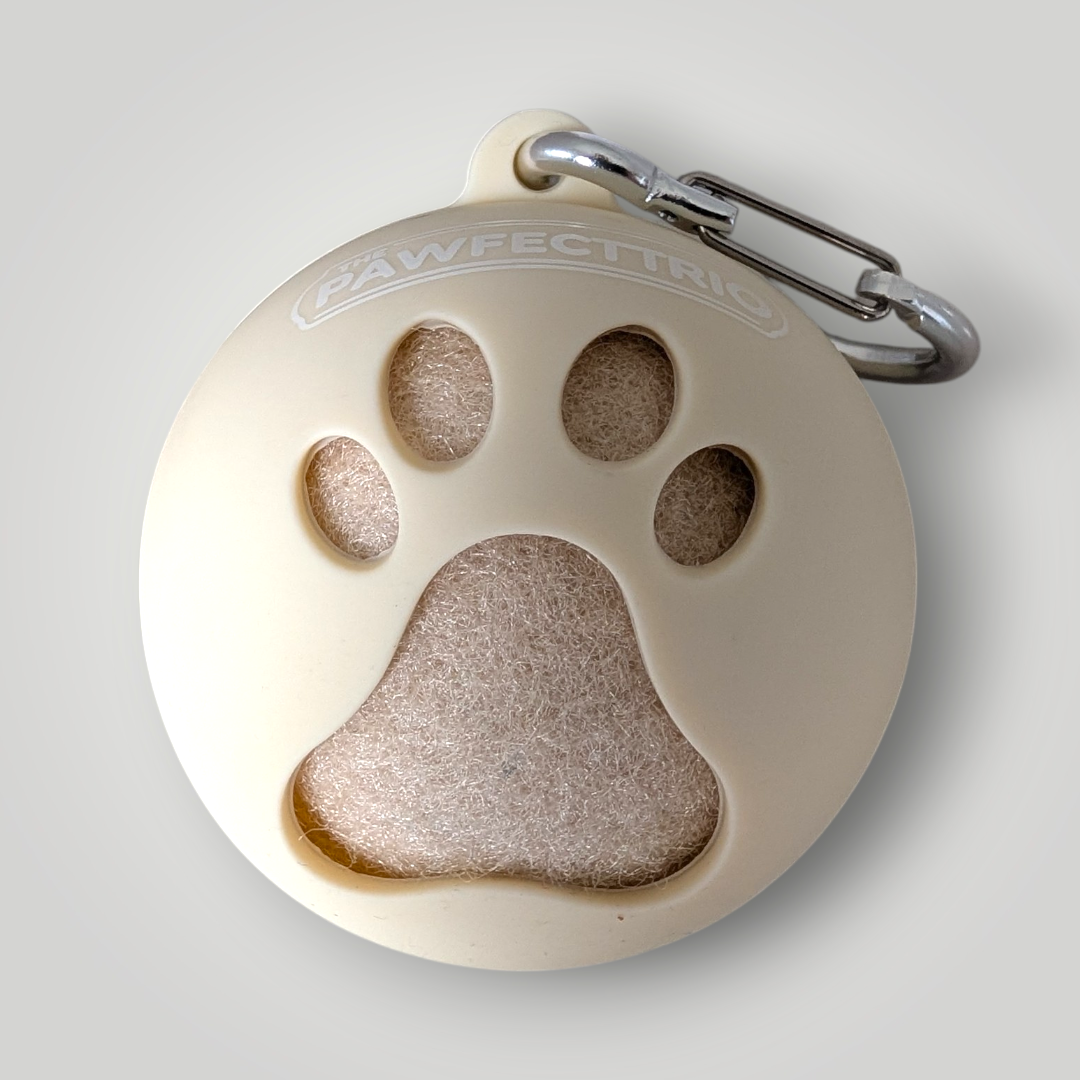 The Pawfect Trio tennis ball holder pet toy with a colorful fabric exterior and a loop for easy carrying or hanging.