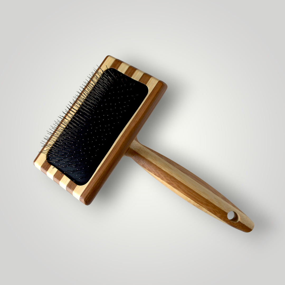Bamboo Slicker Brush for pets by The Pawfect Trio, with fine metal bristles and bamboo handle for grooming cats and dogs.